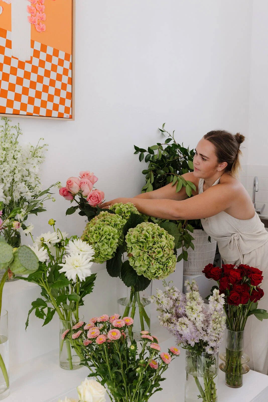 Seasonal blooms being arranged in the studio