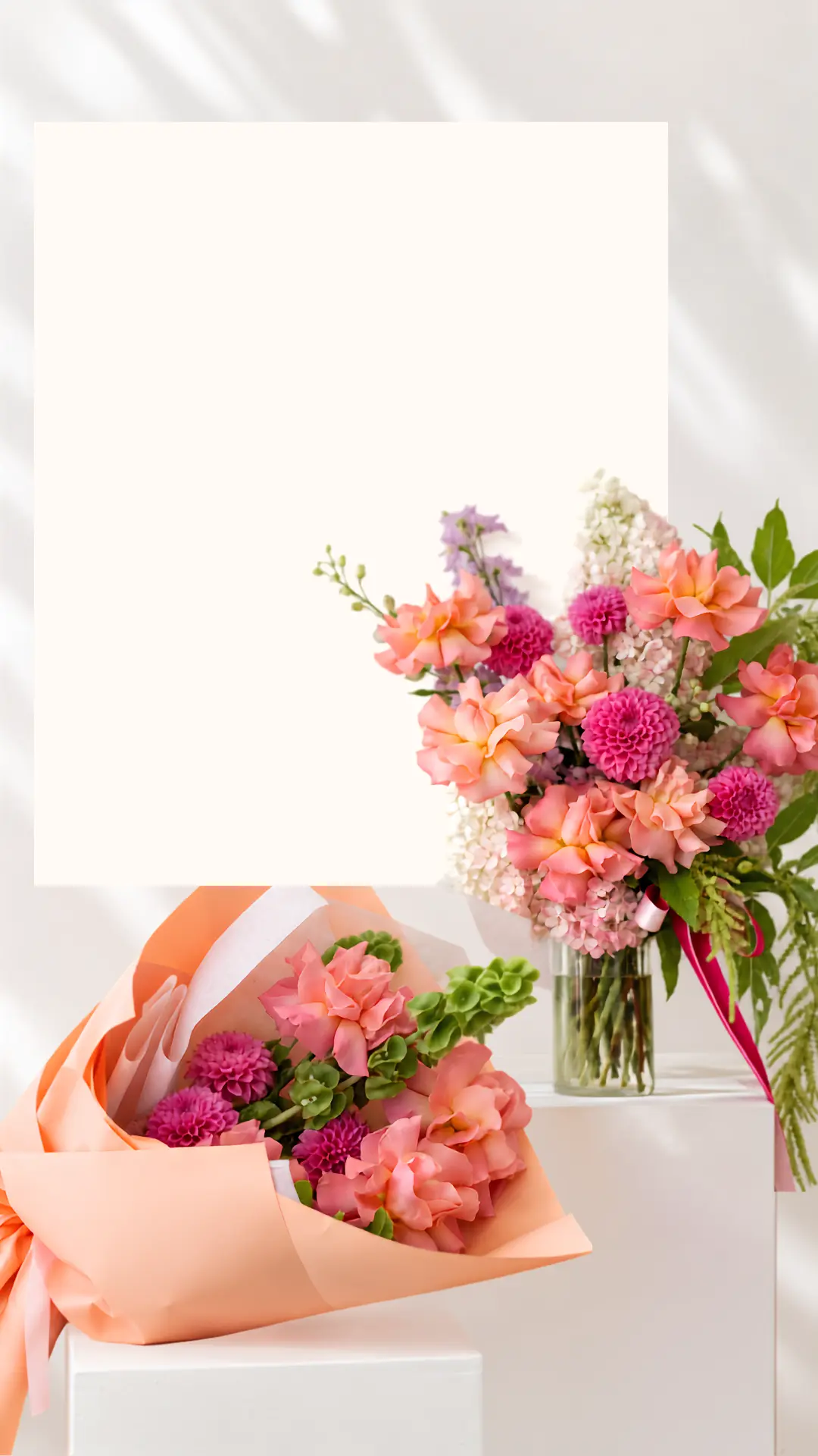 Coral and magenta bouquets arranged around a white text panel