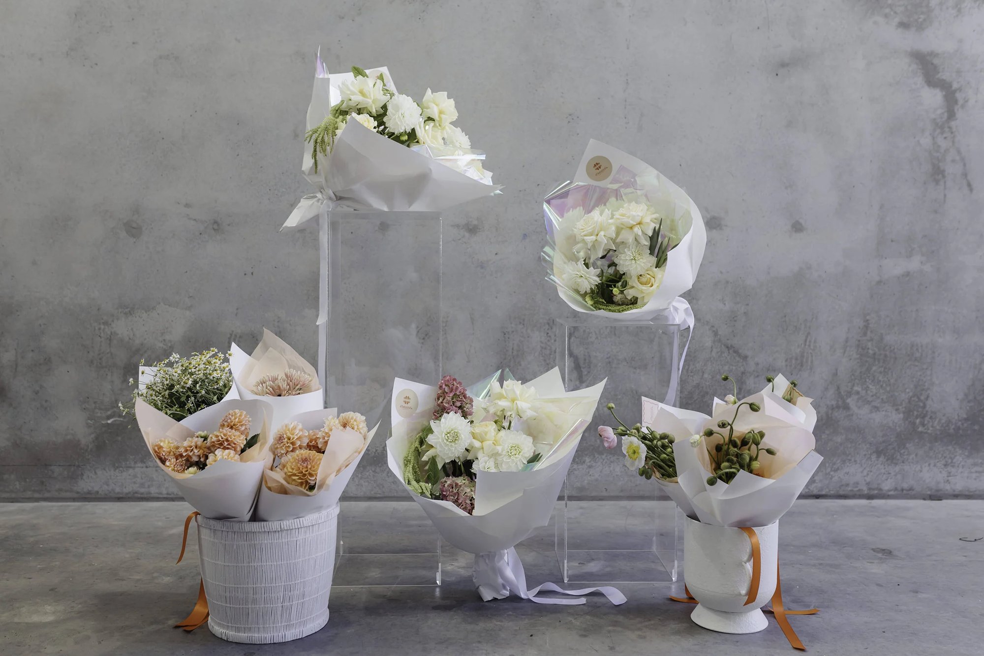 A range of el'botanical bouquets wrapped in white paper