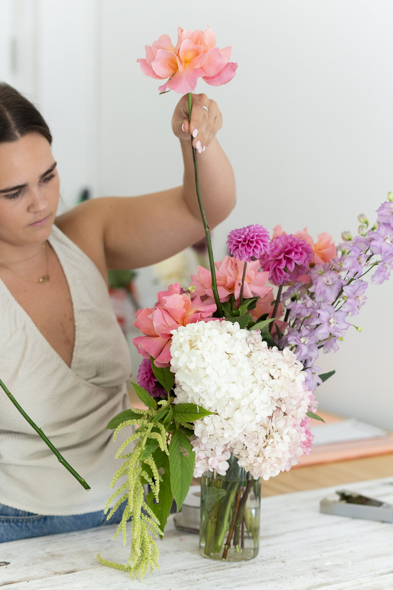 Elly arranging a bouquet at the Bloom Bar bench