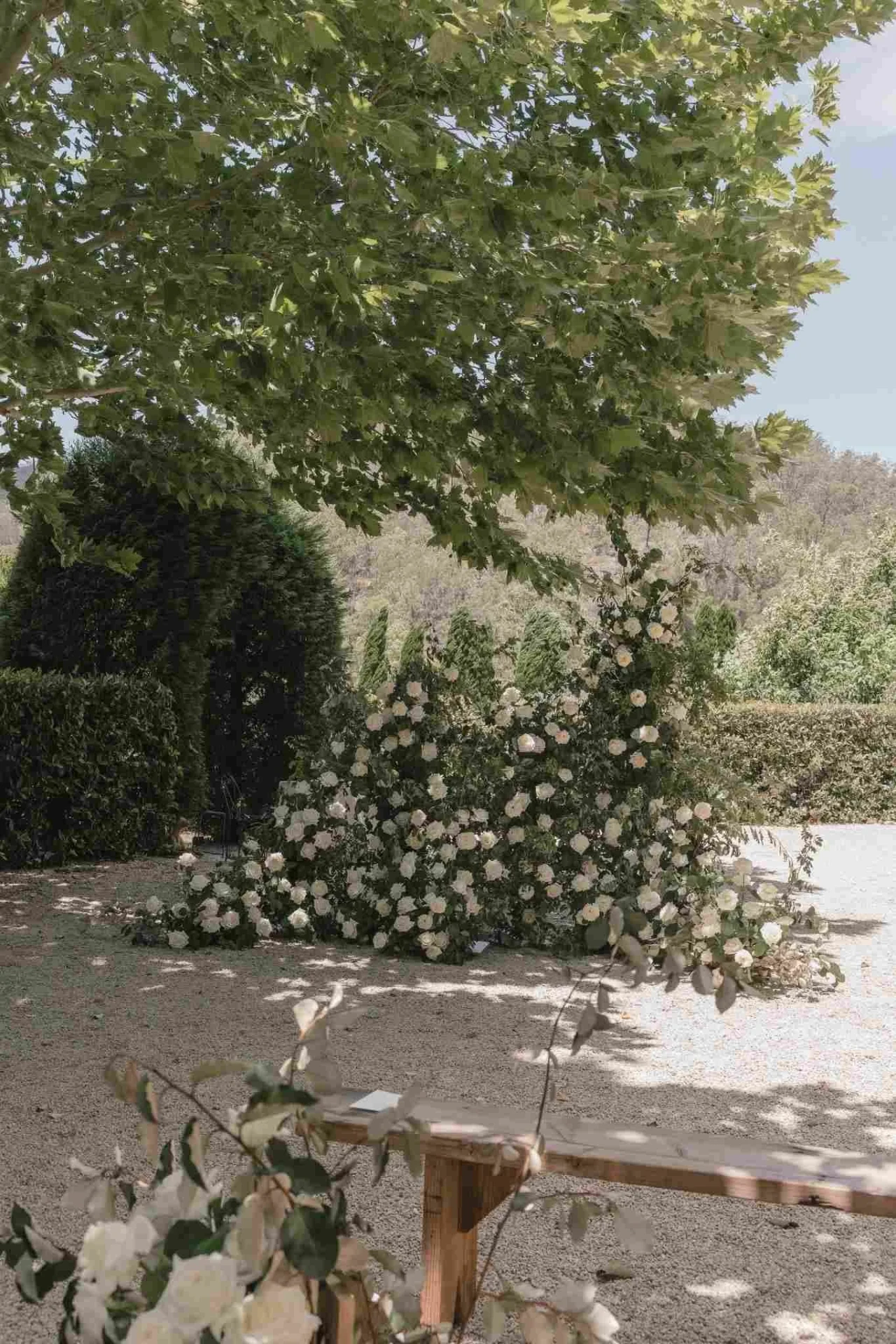 A floral ceremony arch styled in a garden