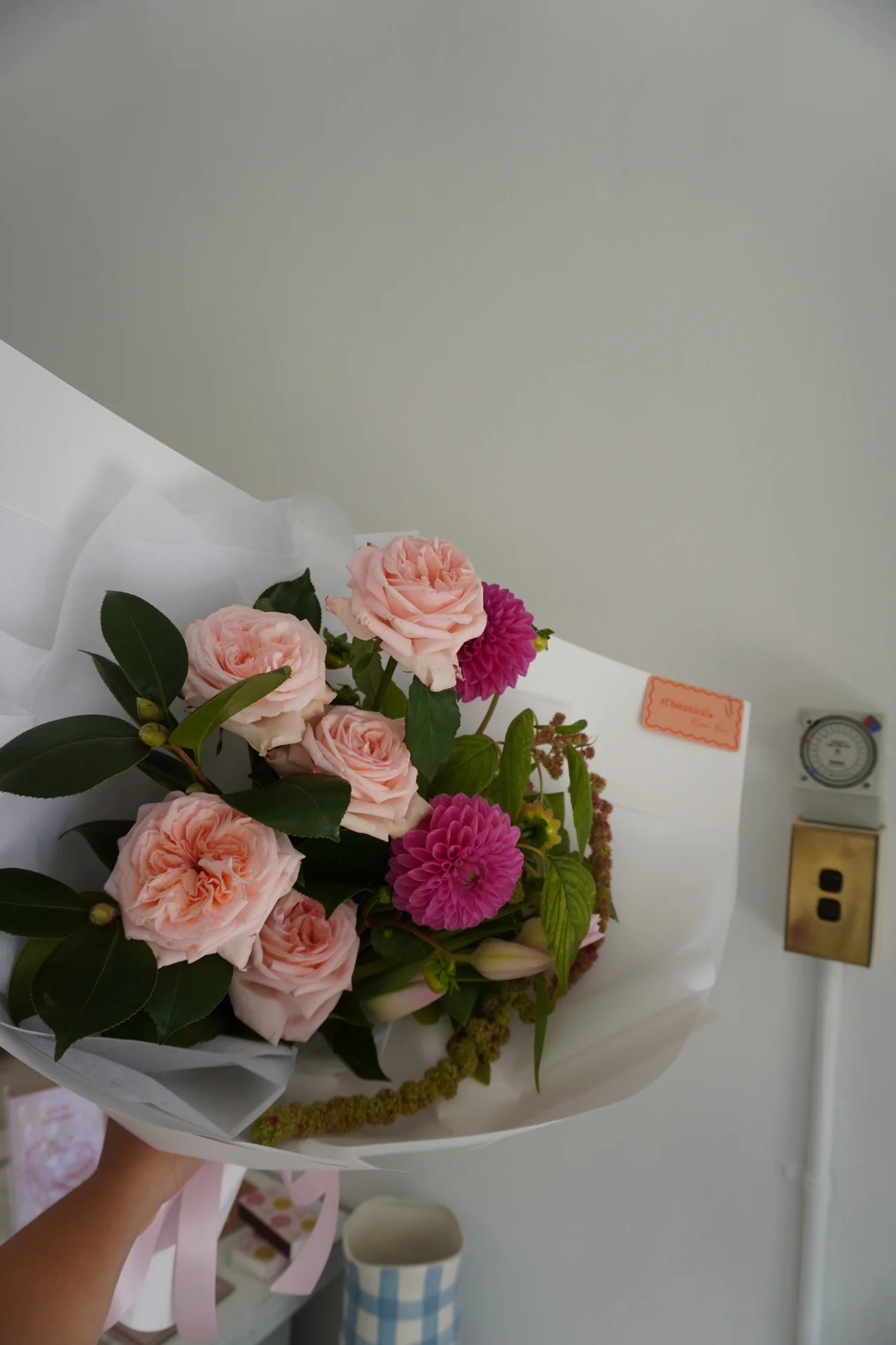 Pink roses and magenta dahlias in white wrap