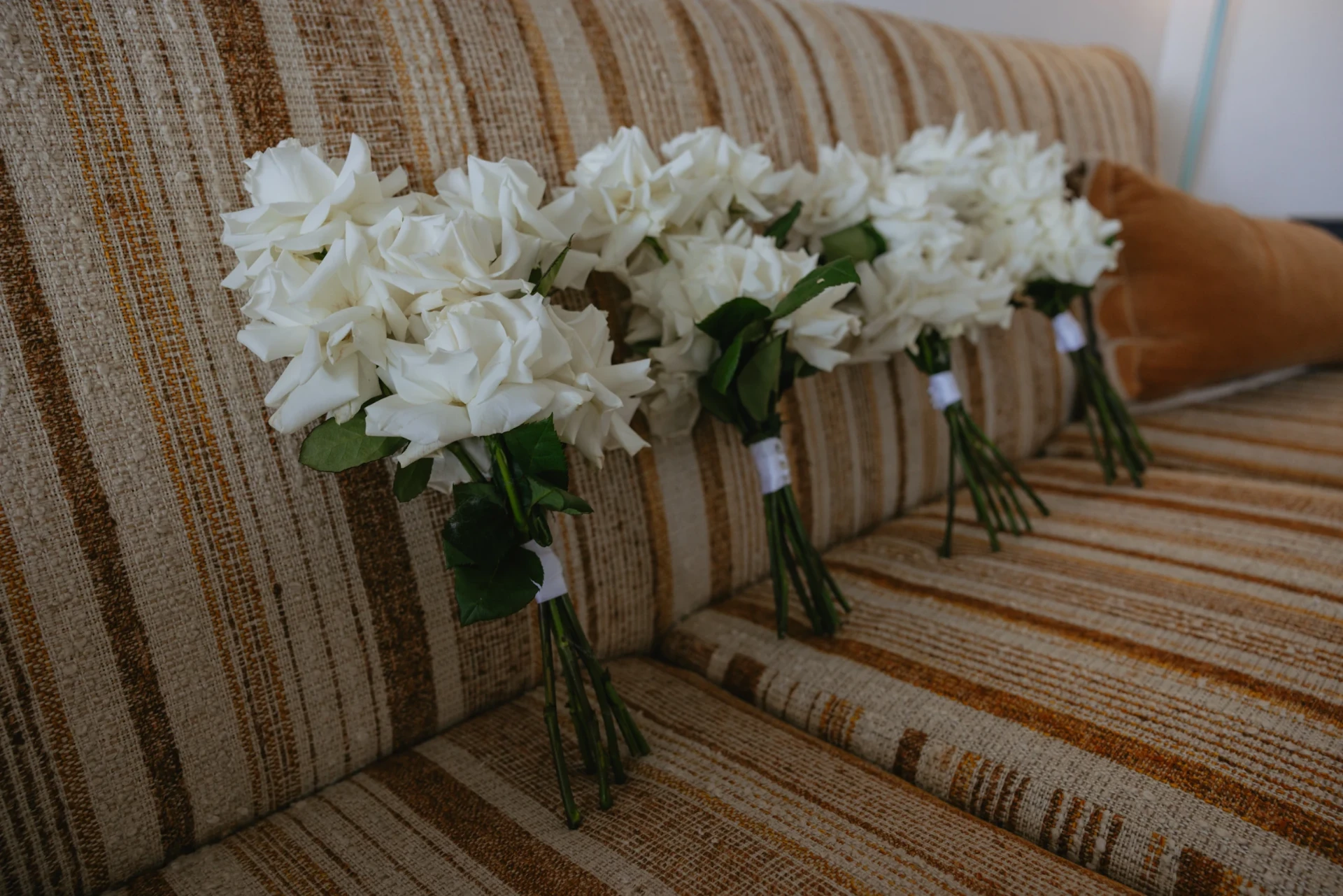 White rose wedding bouquets arranged together before the ceremony