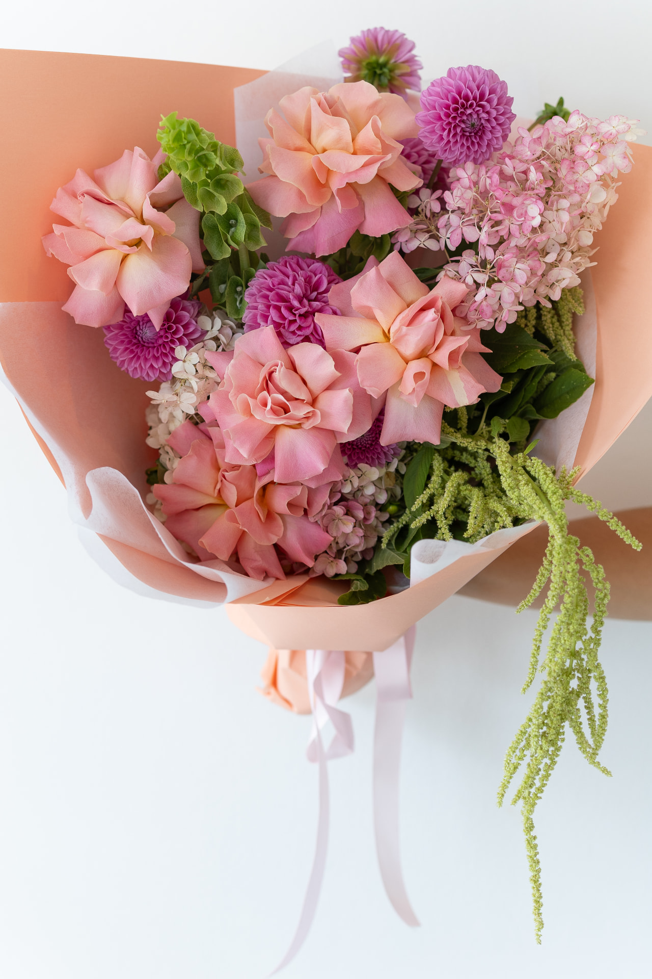 Peach bouquet wrapped in paper ready for delivery